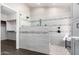 Modern bathroom showcasing glass shower with gray-and-white tiles and an open closet at 20640 N 100Th Ln, Peoria, AZ 85382