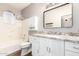 Well-lit bathroom with white vanity, granite countertop, tub, and modern fixtures at 20640 N 100Th Ln, Peoria, AZ 85382