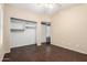 Neutral bedroom with closet and doorway featuring wood-look floors and neutral-colored walls at 20640 N 100Th Ln, Peoria, AZ 85382