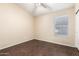 Cozy bedroom featuring wood-look floors, a ceiling fan, and a window with blinds at 20640 N 100Th Ln, Peoria, AZ 85382