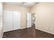 Neutral bedroom with closet and doorway, featuring wood-look floors and neutral-colored walls at 20640 N 100Th Ln, Peoria, AZ 85382