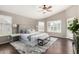 Spacious main bedroom with plantation shutters, a ceiling fan, and a cozy seating area at 20640 N 100Th Ln, Peoria, AZ 85382