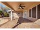 Relaxing covered patio with ceiling fan and brick pavers, great for outdoor living at 20640 N 100Th Ln, Peoria, AZ 85382