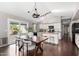 Bright kitchen and dining area with wood floors, granite countertops, and stainless steel appliances at 20640 N 100Th Ln, Peoria, AZ 85382