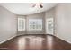 Open living area showcasing dark wood-look tile flooring and lots of natural light from the many windows at 20640 N 100Th Ln, Peoria, AZ 85382