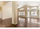 Open living space featuring dark wood-look tile floors, an arched doorway, and neutral walls at 20640 N 100Th Ln, Peoria, AZ 85382