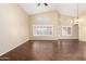 An open living area showcasing dark wood-look tile flooring and lots of natural light from the many windows at 20640 N 100Th Ln, Peoria, AZ 85382