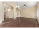 Spacious living room with dark wood-look tile flooring, an arched doorway, and modern lighting at 20640 N 100Th Ln, Peoria, AZ 85382