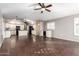 Open floor plan with a kitchen featuring white cabinets, and a living area with dark wood-look tile flooring at 20640 N 100Th Ln, Peoria, AZ 85382