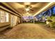 Covered patio featuring pavers and a ceiling fan overlooking backyard at 20640 N 100Th Ln, Peoria, AZ 85382