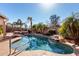 Relaxing pool with waterfalls and lush tropical landscaping creating a serene oasis at 20640 N 100Th Ln, Peoria, AZ 85382