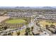 Community aerial view showcasing green spaces, residential areas, streets, and parks with mountain views at 21359 E Camacho Rd, Queen Creek, AZ 85142