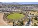 Aerial view of the community showcasing a central park, green spaces, and residential streets with mountain backdrop at 21359 E Camacho Rd, Queen Creek, AZ 85142