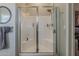 Bathroom with tiled shower featuring glass doors and a built-in bench at 21359 E Camacho Rd, Queen Creek, AZ 85142