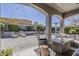 Inviting covered patio with outdoor furniture, fire pit, and lush landscaping for relaxing and entertaining at 21359 E Camacho Rd, Queen Creek, AZ 85142