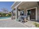 Relaxing covered patio featuring a comfortable seating area, BBQ, and a view of the sparkling pool at 21359 E Camacho Rd, Queen Creek, AZ 85142