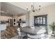 Dining room featuring hardwood floors, chandelier, and breakfast bar with views to kitchen at 21359 E Camacho Rd, Queen Creek, AZ 85142