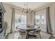 Bright dining room featuring hardwood floors, decorative chandelier, and large windows at 21359 E Camacho Rd, Queen Creek, AZ 85142