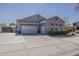 Spacious three-car garage showcasing ample parking space and additional storage on a sunny day at 21359 E Camacho Rd, Queen Creek, AZ 85142