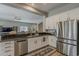 Kitchen featuring stainless steel appliances, granite countertops and white cabinetry at 21359 E Camacho Rd, Queen Creek, AZ 85142