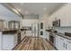 Modern kitchen featuring white cabinetry, stainless steel appliances, and a convenient breakfast bar at 21359 E Camacho Rd, Queen Creek, AZ 85142