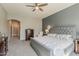 Spacious main bedroom suite with a gray accent wall, carpet, and large windows with natural light at 21359 E Camacho Rd, Queen Creek, AZ 85142