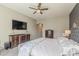 Main bedroom suite featuring a gray accent wall, soft carpet, and a window with natural light at 21359 E Camacho Rd, Queen Creek, AZ 85142