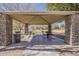 Covered picnic area with stone pillars, tables, and BBQ grills, perfect for outdoor gatherings and relaxation at 21359 E Camacho Rd, Queen Creek, AZ 85142