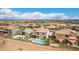 Expansive aerial shot showcasing a home with a private pool and beautifully landscaped backyard in a tranquil neighborhood at 21622 N Backus Dr, Maricopa, AZ 85138