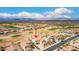 Stunning aerial view of a meticulously landscaped property with a sparkling pool and golf course views at 21622 N Backus Dr, Maricopa, AZ 85138