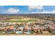 Expansive aerial view of a golf course community in Arizona, highlighting the neighborhood layout and scenic views with beautiful blue sky at 21622 N Backus Dr, Maricopa, AZ 85138