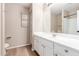 A bathroom with single vanity, a soaking tub with shower, and wood-look flooring at 21622 N Backus Dr, Maricopa, AZ 85138