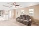 A bonus room showcasing a reclining couch with cup holders and multiple windows at 21622 N Backus Dr, Maricopa, AZ 85138