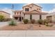 Charming two-story home with a well-maintained yard and desert landscaping at 21622 N Backus Dr, Maricopa, AZ 85138