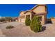 Charming home featuring a three-car garage and appealing desert landscaping, set against a clear blue sky at 224 N 236Th Ave, Buckeye, AZ 85396