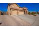 Two-story home boasts a three-car garage and desert landscaping, showcasing the property's curb appeal at 224 N 236Th Ave, Buckeye, AZ 85396