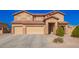 Spacious home with a three-car garage and well-maintained front yard and appealing desert landscaping at 224 N 236Th Ave, Buckeye, AZ 85396