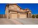 Lovely two-story home with three-car garage, paver driveway, tile roof and desert landscaping at 224 N 236Th Ave, Buckeye, AZ 85396