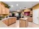 Bright open kitchen featuring an island, granite countertops and views of the dining and living area at 224 N 236Th Ave, Buckeye, AZ 85396