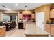 Bright open kitchen featuring an island, granite countertops and views of the dining area at 224 N 236Th Ave, Buckeye, AZ 85396