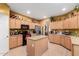 Well-equipped kitchen featuring an island, stainless steel appliances, and maple cabinets at 224 N 236Th Ave, Buckeye, AZ 85396