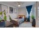 Bright bedroom with modern decor, including framed posters, a ceiling fan, and stylish furnishings at 22474 E Lawndale E Pl, Queen Creek, AZ 85142