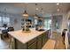 A kitchen island with stone countertops, pendant lights and views of dining and living areas at 22474 E Lawndale E Pl, Queen Creek, AZ 85142