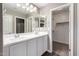 Bathroom with double sinks, framed mirror and updated fixtures at 240 W Juniper Ave # 1146, Gilbert, AZ 85233