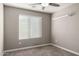 Neutral bedroom features a window, carpet, ceiling fan and floating shelf at 240 W Juniper Ave # 1146, Gilbert, AZ 85233