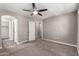 Carpeted bedroom featuring a ceiling fan and multiple entrances at 240 W Juniper Ave # 1146, Gilbert, AZ 85233