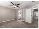 Spacious carpeted bedroom with a ceiling fan and an attached bathroom at 240 W Juniper Ave # 1146, Gilbert, AZ 85233