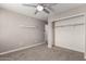 Neutral bedroom featuring a fan, carpet, and a closet with open doors to maximize storage at 240 W Juniper Ave # 1146, Gilbert, AZ 85233