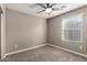 Carpeted bedroom featuring a window with blinds, offering natural light and a simple aesthetic at 240 W Juniper Ave # 1146, Gilbert, AZ 85233