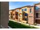 Townhome row of multiple stories with colorful exteriors and lush lawn at 240 W Juniper Ave # 1146, Gilbert, AZ 85233